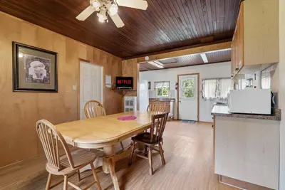 a kitchen and dining room with a table and chairs at Relaxing Lakefront Cabin in Bailieboro