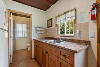 a kitchen with a sink and a toilet and a window at Relaxing Lakefront Cabin in Bailieboro