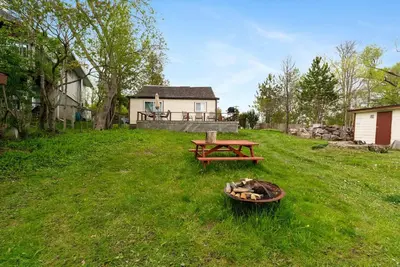 a picnic table and a bench in a yard at Relaxing Lakefront Cabin in Bailieboro