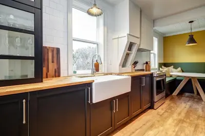 a kitchen with a white sink and a large window at The Marigold - Gorgeously remodelled PEC farmhouse in West Lake