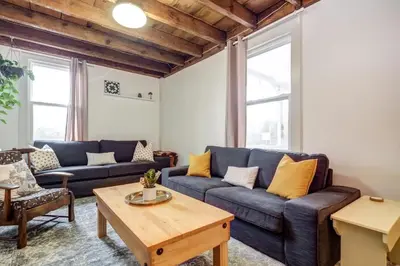a living room with a couch and a coffee table at The Marigold - Gorgeously remodelled PEC farmhouse in West Lake