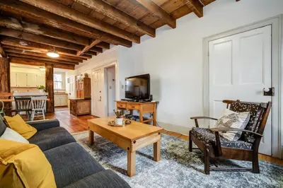a living room with a couch and a table at The Marigold - Gorgeously remodelled PEC farmhouse in West Lake