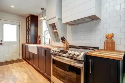 a kitchen with a stove and a sink at The Marigold - Gorgeously remodelled PEC farmhouse in West Lake