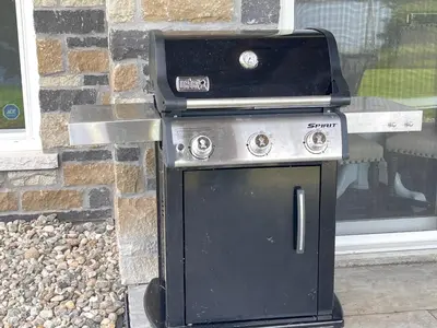 a stove sitting in front of a brick wall at Lakeside Maison in Hillier