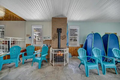 a room with blue chairs and a fireplace at Marmora and Lake Inn and Victorian Diner-2025 Group Reunion Home for up to 32 guests in Marmora