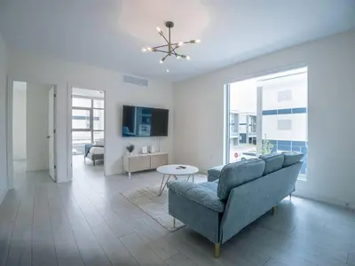 a living room with a couch and a table at Casa Lago 5 Bed Waterfront House in Innisfil
