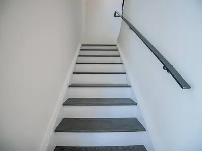 a staircase in a house with white walls and wooden floors at Casa Lago 5 Bed Waterfront House in Innisfil