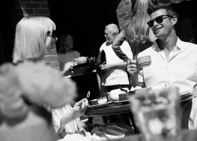 a group of people sitting at a table eating food at L'auberge De France Inn in Belleville