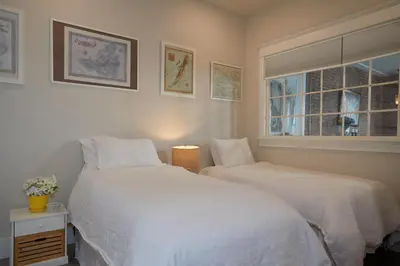 a bedroom with two beds and a window at L'auberge De France Inn in Belleville