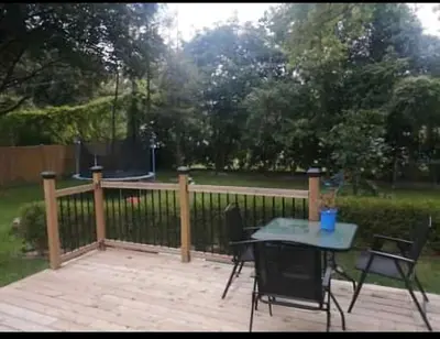 a patio with a table and chairs and a ping at Forest city House -Rooms in a family style in London