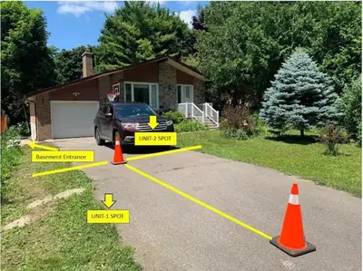 a driveway with caution signs in front of a house at Millpond Basement Units in Richmond Hill
