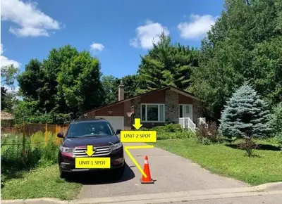 a car is parked in front of a house at Millpond Basement Units in Richmond Hill