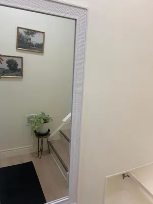 a mirror in a hallway next to a stairway at Millpond Basement Units in Richmond Hill