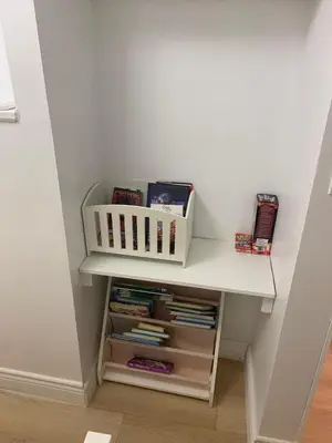 a book shelf in a room with books on it at Millpond Basement Units in Richmond Hill