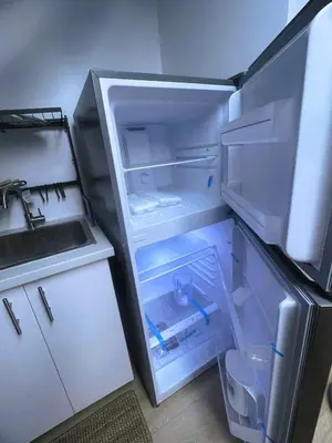 an empty refrigerator with its door open in a kitchen at Millpond Basement Units in Richmond Hill