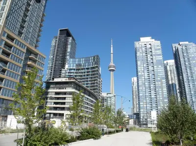 a city with tall buildings and the cn tower at Stylish Condo Downtown Near CN Tower - Free parking in Toronto