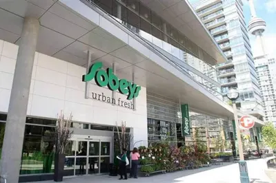 people standing outside of a store in a city at Stylish Condo Downtown Near CN Tower - Free parking in Toronto