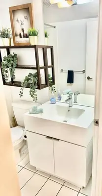 a white bathroom with a sink and a toilet at Stylish Condo Downtown Near CN Tower - Free parking in Toronto