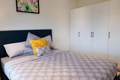 a bedroom with a bed and white cabinets at 2bhk Luxury brand new pvt suite Kitchener in Kitchener