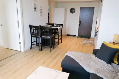 a living room with a couch and a table and chairs at 2bhk Luxury brand new pvt suite Kitchener in Kitchener