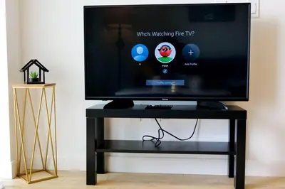 a tv on a black stand with a black table at 2bhk Luxury brand new pvt suite Kitchener in Kitchener