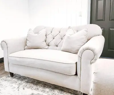 a white couch sitting in a living room at Cellar Suite at Winery and Vineyard in Waterford