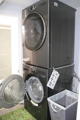 a washer and dryer stacked on top of each other at Garden 2 BR Apt - Free Parking Wifi Laundry Workstation in Brampton
