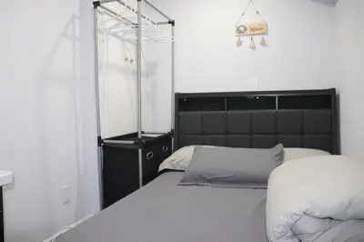 a bed with a black headboard in a bedroom at Garden 2 BR Apt - Free Parking Wifi Laundry Workstation in Brampton