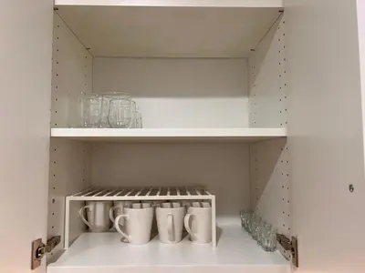 a cupboard with mugs and glasses in it at 2 Bedroom 1 Parking Basement Unit in Richmond Hill