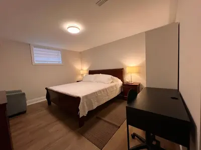 a bedroom with a bed and a desk in it at 2 Bedroom 1 Parking Basement Unit in Richmond Hill
