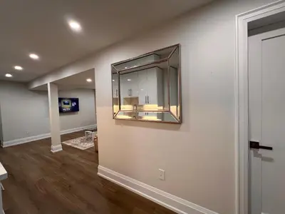 a living room with a mirror on the wall at 2 Bedroom 1 Parking Basement Unit in Richmond Hill