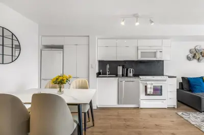 a kitchen and living room with a table and a kitchen and a dining room at Beautiful 2 Bedroom Downtown Toronto Condo with free parking in Toronto