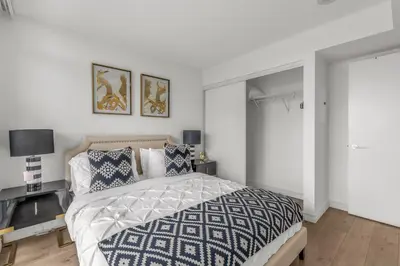 a bedroom with a bed with a blue and white comforter at Beautiful 2 Bedroom Downtown Toronto Condo with free parking in Toronto