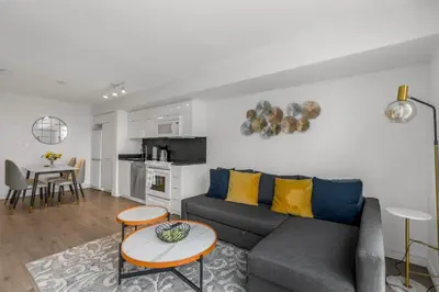 a living room with a couch and a table at Beautiful 2 Bedroom Downtown Toronto Condo with free parking in Toronto