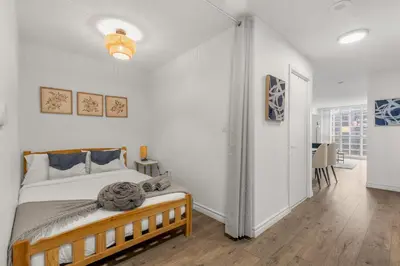 a bedroom with a bed and a hallway with a table at Beautiful 2 Bedroom Downtown Toronto Condo with free parking in Toronto