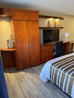 a hotel room with a bed and a desk at Princess Motel in Bobcaygeon