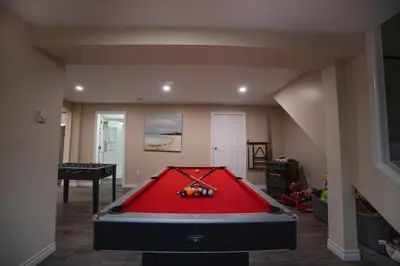 a living room with a pool table in it at Muskoka Waterfront Cottage - Moon River with HOT TUB in Bala