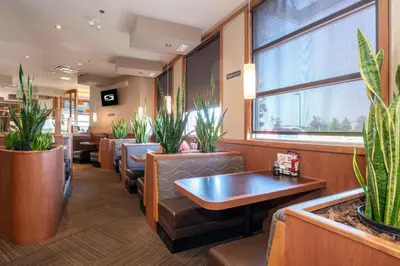 a waiting room with chairs and potted plants at Sandman Hotel Oakville in Oakville