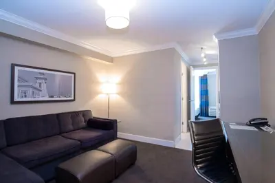 a living room with a couch and a table at Sandman Hotel Oakville in Oakville