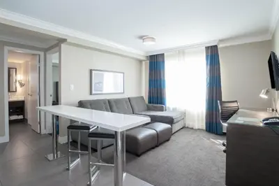 a living room with a couch and a table at Sandman Hotel Oakville in Oakville