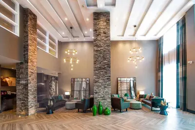 a lobby with couches and chairs at Sandman Hotel Oakville in Oakville