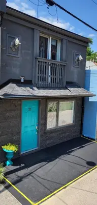 a house with a blue door and a balcony at Downtown Toronto House Central 2BED 2BATH Subway Free Parking in Toronto