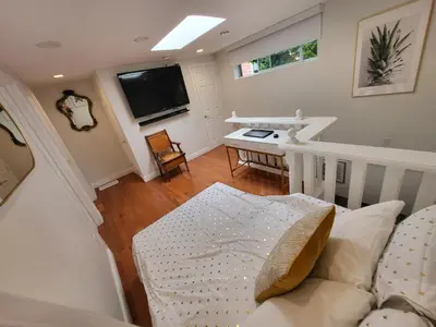 a living room with a couch and a flat screen tv at Downtown Toronto House Central 2BED 2BATH Subway Free Parking in Toronto