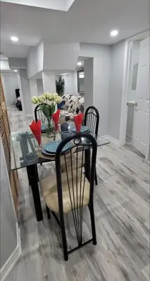 a dining room table and chairs in a living room at Elegant & Luxurious 3 Bedroom Home in Mississauga