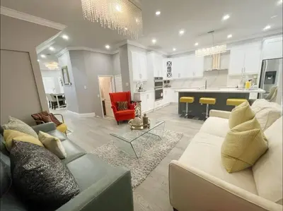 a large living room with a couch and a table at Elegant & Luxurious 3 Bedroom Home in Mississauga