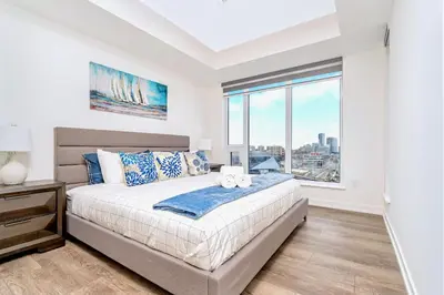 a bedroom with a bed and a large window at Condo Unit with Stunning Views & Amenities in Kitchener
