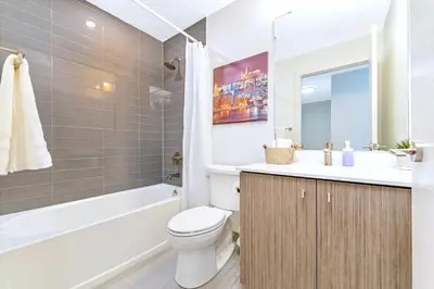 a bathroom with a toilet and a sink and a tub at Condo Unit with Stunning Views & Amenities in Kitchener