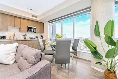 a living room and kitchen with a couch and a table at Condo Unit with Stunning Views & Amenities in Kitchener