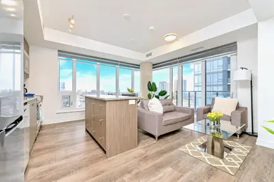 a living room with a couch and a table at Condo Unit with Stunning Views & Amenities in Kitchener