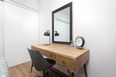a bedroom with a desk with a mirror and a chair at Perfect Condo Sleeps 4 Across from Cn Tower! in Toronto